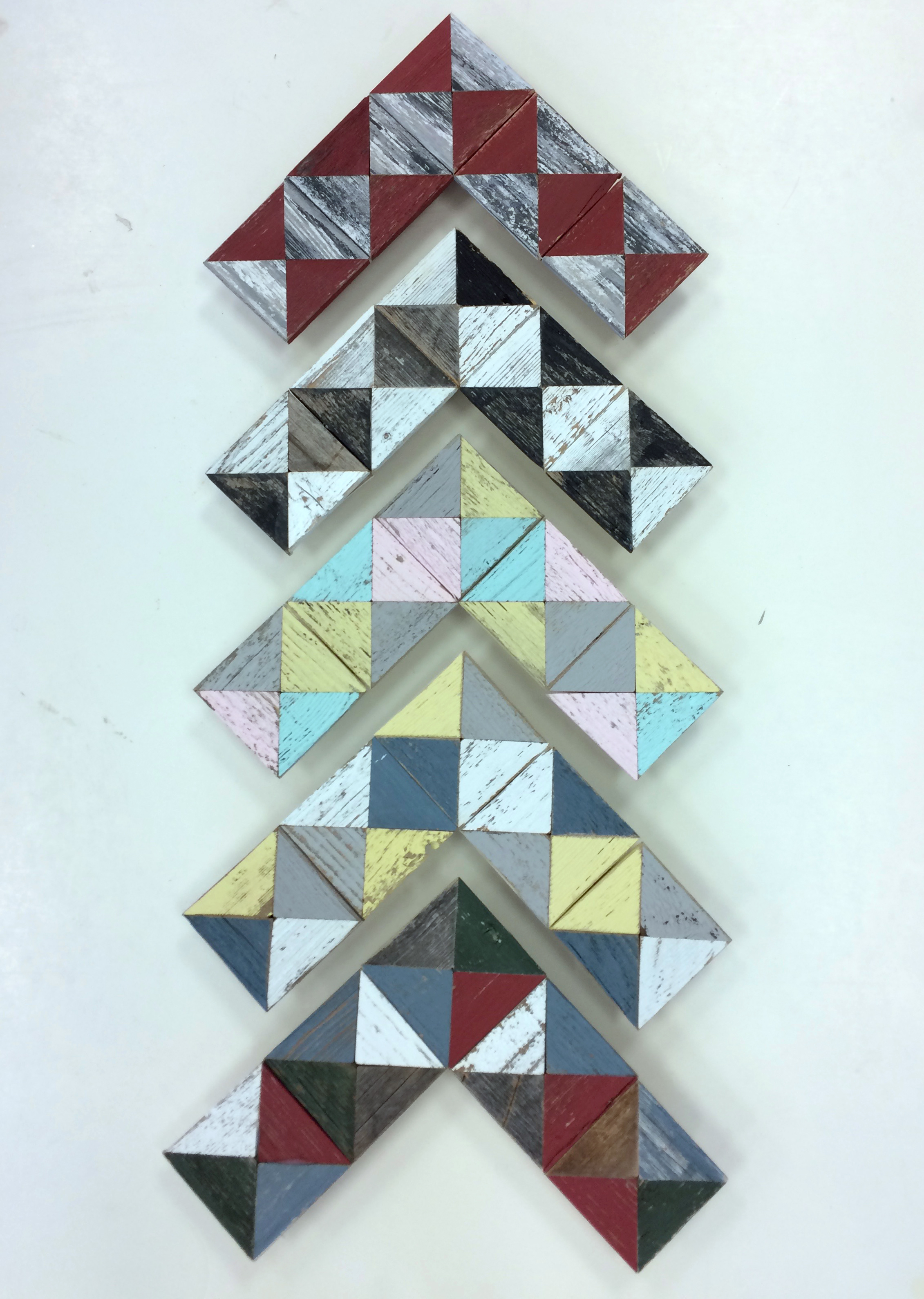 Barnwood triangle cut-outs pieced together to form a variety of beautiful patterns